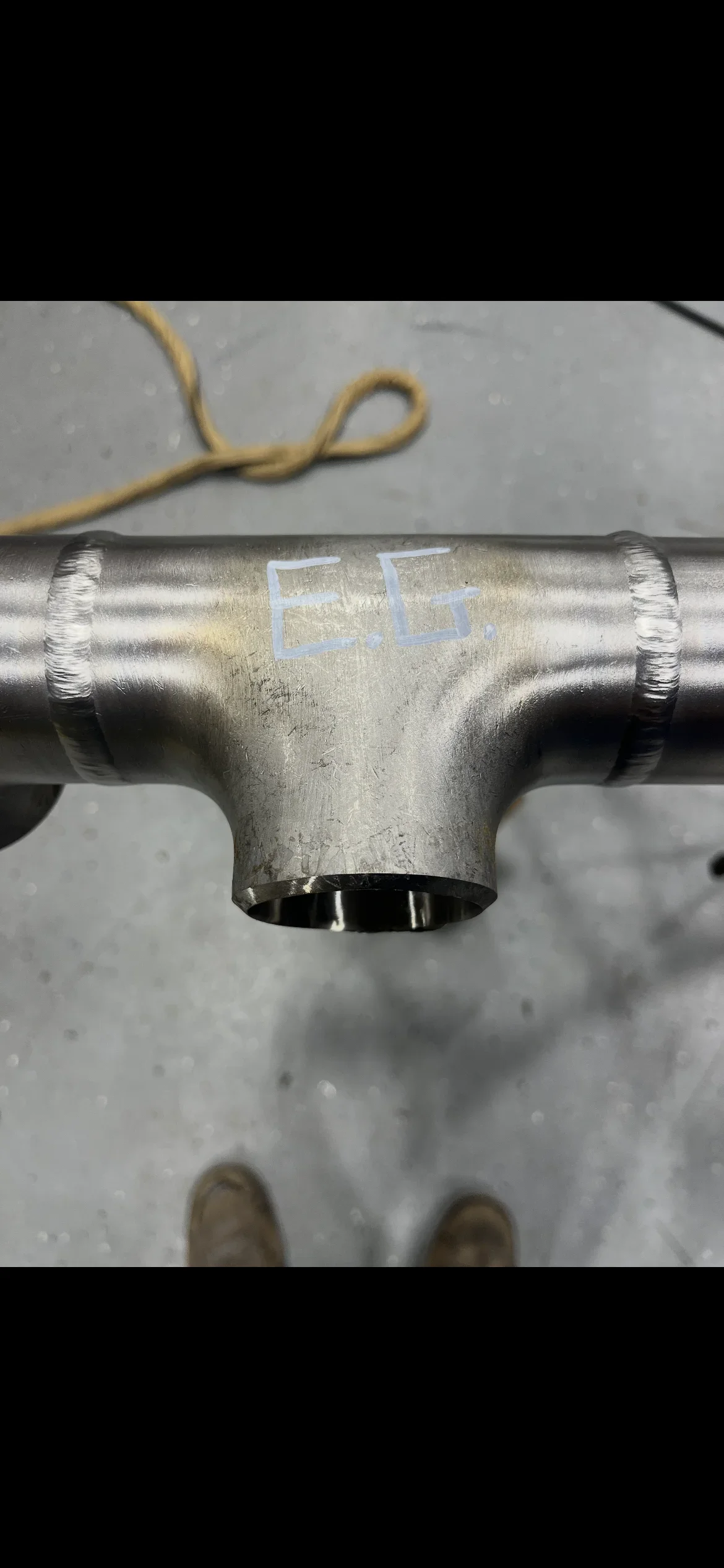 Galvanized steel tee fitting with welded connections and identification marking