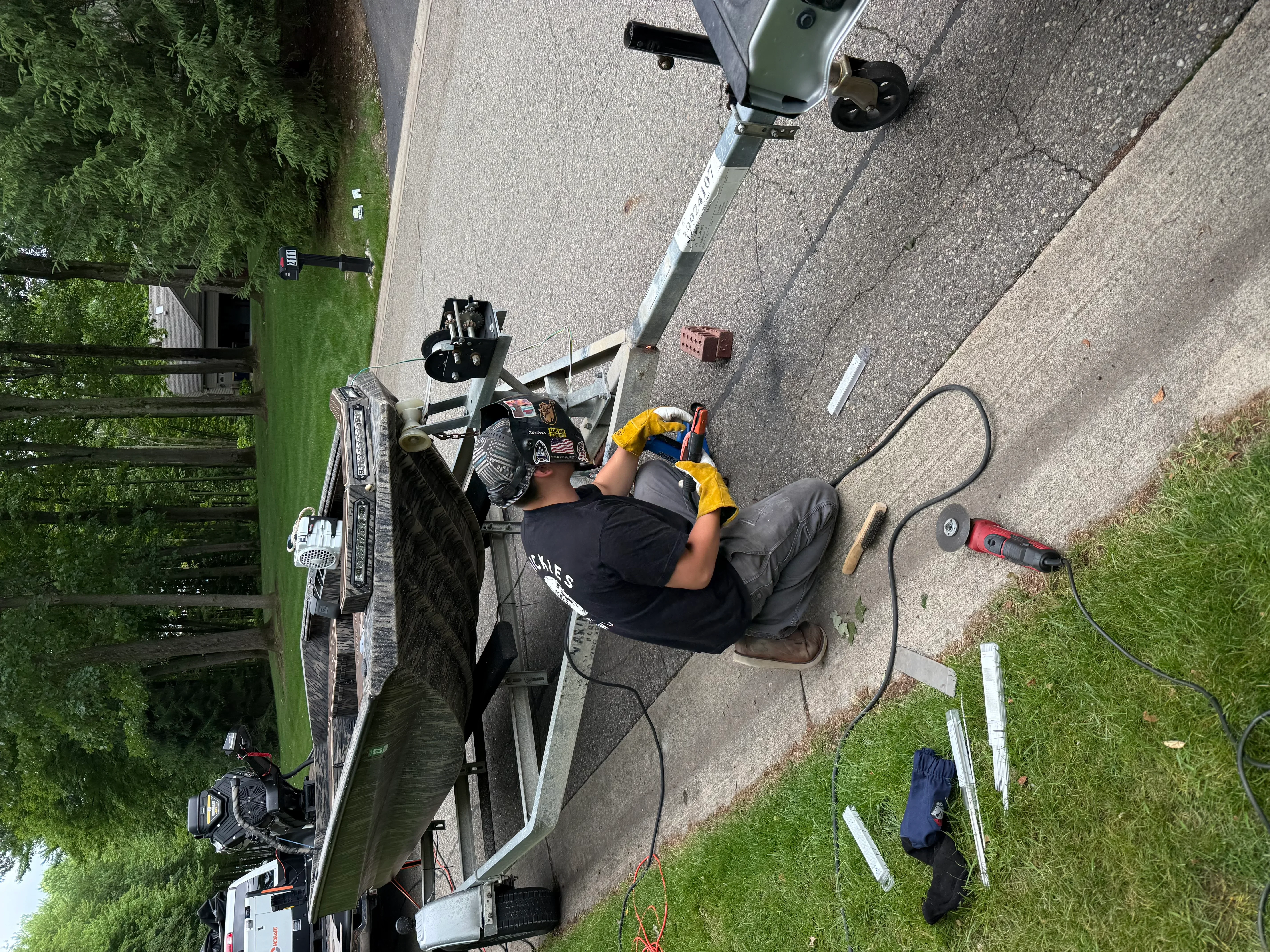 Technician installing seamless aluminum gutter system on residential roof edge